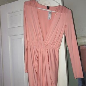 Light pink form fitting high low dress.